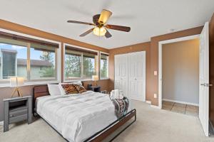 a bedroom with a bed and a ceiling fan at Modern Amenities Gas Fireplace Central Location in Spokane