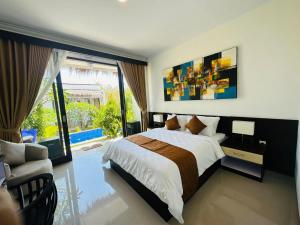 a bedroom with a bed and a large window at Maliqa Villas Nusa Penida in Nusa Penida +22 photos
