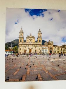 a large building with pigeons in front of it at Bogotá Kings 101 in Bogotá