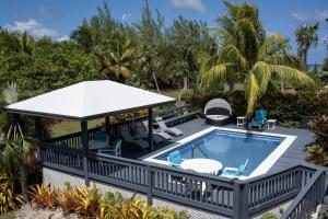 an outdoor pool with a gazebo and chairs at Trident Estate estate in Palmetto Point