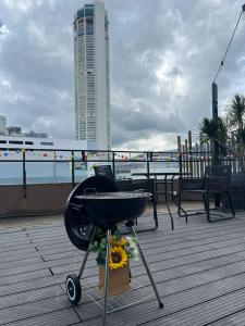a barbecue grill on a boardwalk with a building at Le Dream Boutique Hotel in George Town