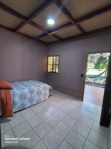 a bedroom with a bed and a tiled floor at Los Cipreses-10persons-Deep connection with nature 