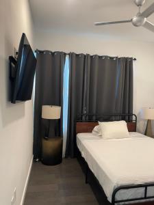 um quarto com 2 camas e uma cortina preta em Luxury Penthouse w Glass Wall, Roof Deck, Firepit in DT Austin em Austin