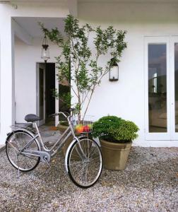 a bike parked in front of a house at The White House Homestay in Pantai Cenang