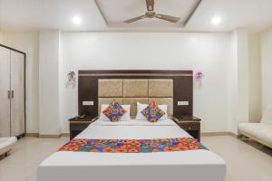 a bedroom with a large bed and a couch at FabHotel Star Residency in Nagpur