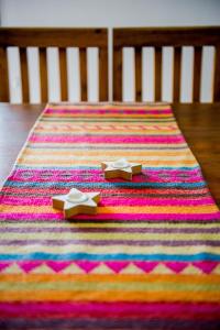 a colorful rug with two shoes on a table at ESTE SUEÑO in San Martín
