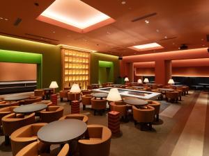 a restaurant with tables and chairs and a pool table at Hotel Il Palazzo in Fukuoka