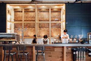 2 personnes préparant des repas à un comptoir dans une cuisine dans l'établissement Lampstand STAY Asahikawa, à Asahikawa
