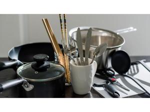 a kitchen counter with a stove with utensils and a pot at Hotel Thomas Nago - Vacation STAY 40430v in Nago