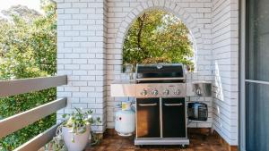 an outdoor kitchen with a stove and an arched window at MondoDan in McCrae