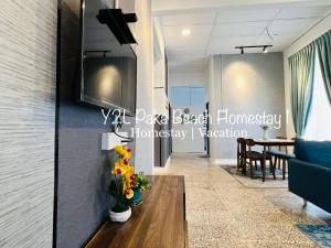a living room with a couch and a table at YL Legacy Homestay Paka 1 - Near Beach & Opposite Surau in Paka