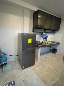 a kitchen with a counter and a refrigerator at Eri transient house Tagum in Tagum