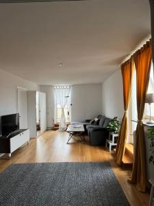 a living room with a couch and a tv at Sky view apartment, Stockholm in Solna