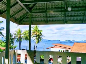 a view of the ocean from a balcony of a house at บ้านตึกเกสเฮ้าส์แอนด์โฮมสเตย์ขนอม in Ban Thung Khanan