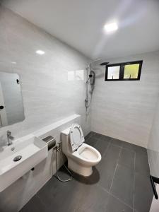 a bathroom with a white toilet and a sink at TheDot 903 @ A’Famosa Villa NEW VILLA in Kampong Alor Gajah