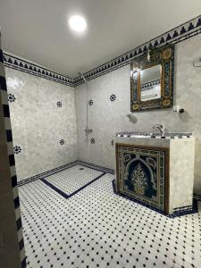 a bathroom with a fireplace and a tiled floor at Riad Ranya in Fès