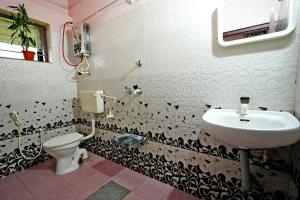 a bathroom with a sink and a toilet at CoffeeINN Homestay - Jeep Ride, Water Activities, Home Food in Sakleshpur