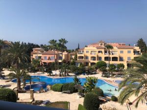 an aerial view of a resort with a swimming pool at Limnaria Gardens - 1 bedroom, sunny apartment with stunning pool views in Paphos City