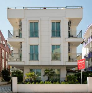 a white building with windows and a no parking sign at The Room Hotel & Apartments in Antalya