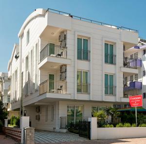 a white building with a sign in front of it at The Room Hotel & Apartments in Antalya