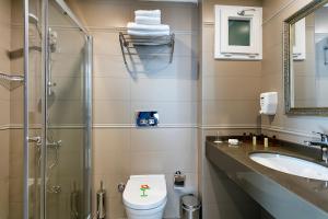 a bathroom with a toilet and a sink and a shower at The Room Hotel & Apartments in Antalya