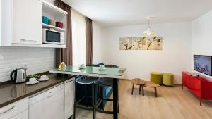 a kitchen with a counter and a table in a room at The Room Hotel & Apartments in Antalya