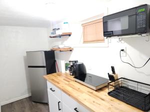 a kitchen with a counter with a coffee machine on it at Lovely Private 2 Bedroom Suite near EWR/NYC in Newark