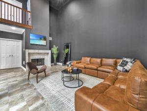 a living room with a couch and a fireplace at LUX 4BR Home w/ Hot tub & Pool, 15 min to downtown in Houston