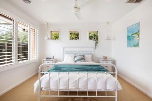 a white bed in a room with white walls at Preston Alfresco Poolside Retreat Rye in Rye +24 photos