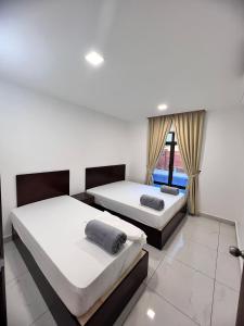 two beds in a room with a window at TheDot 903 @ A’Famosa Villa NEW VILLA in Kampong Alor Gajah