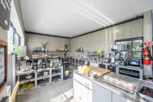 a large kitchen with a lot of appliances in it at BLANCA8 - 21 - Bali Invest Club in Canggu