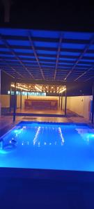 a large swimming pool in a building at night at استراحة المرجان 