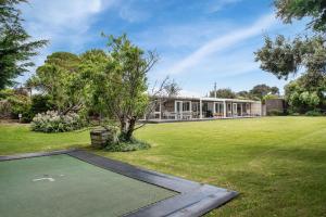 an image of a house with a green yard at Blairgowrie Beauty By The Beach in Blairgowrie