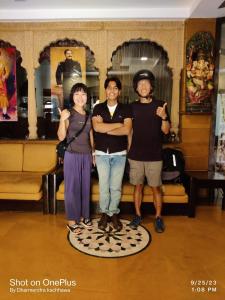 a group of three people posing for a picture at The Elite Castle in Jaisalmer