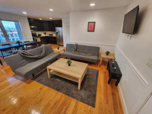 a living room with a couch and a table at Luxurious 2 bed ! mins to NYC! in Union City
