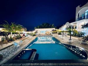 a swimming pool in a resort at night at Santorini Villa Cam Ranh in Cam Ranh