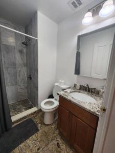 a bathroom with a toilet and a shower and a sink at Luxurious 2 bed ! mins to NYC! in Union City