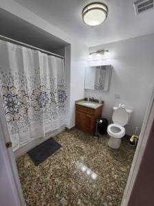 a bathroom with a toilet and a sink at Luxurious 2 bed ! mins to NYC! in Union City