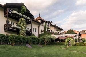 an exterior view of a house with a yard at Hotel Magdalener Hof in Bolzano