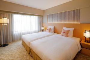 Ένα ή περισσότερα κρεβάτια σε δωμάτιο στο Kyoto Brighton Hotel