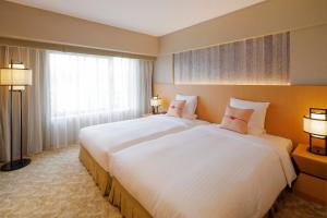 Postel nebo postele na pokoji v ubytování Kyoto Brighton Hotel + 37 fotografií
