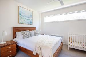 a bedroom with a crib and a large window at The Royal Apartment in Mornington in Mornington