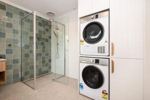a laundry room with two washer and dryer at Blissful Serenity in Somers Walk to the beach in Somers