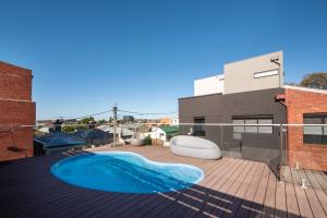 a swimming pool on the roof of a building at Loft Living Close to the MCG in Melbourne