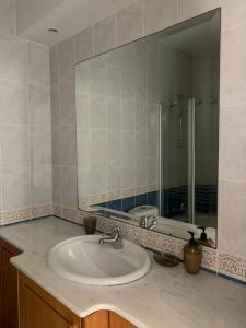 baño con lavabo y espejo grande en Spacious 3 bed, 2 bath maisonette in Regina Gardens en Paphos