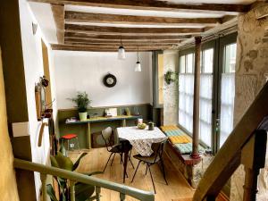 a dining room with a table and chairs in a room at Tour St Sauveur in Bellême