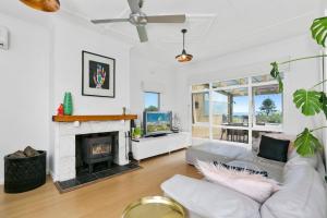 a living room with a couch and a fireplace at Nullegai Spa and Views in Dromana