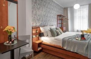 a bedroom with a bed and a table with a table sidx sidx sidx at 4 Elements Apartments by Adrez in Prague
