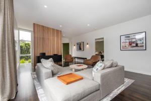 a living room with a couch and a table at The Pavilion with pool St Andrews Beach in Saint Andrews Beach