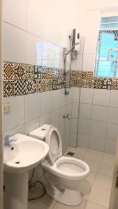 een badkamer met een toilet en een wastafel bij Rio Vista Bed and Breakfast in Dagupan